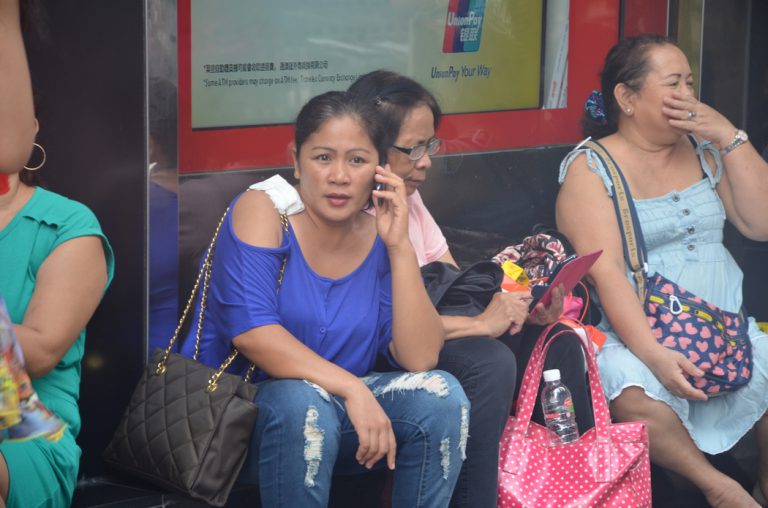 A domestic worker using smartphone for call