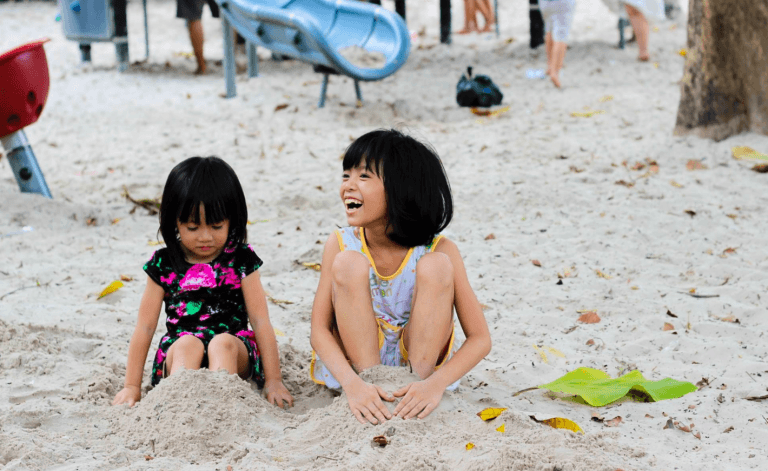 children playing on the beach, happy faces