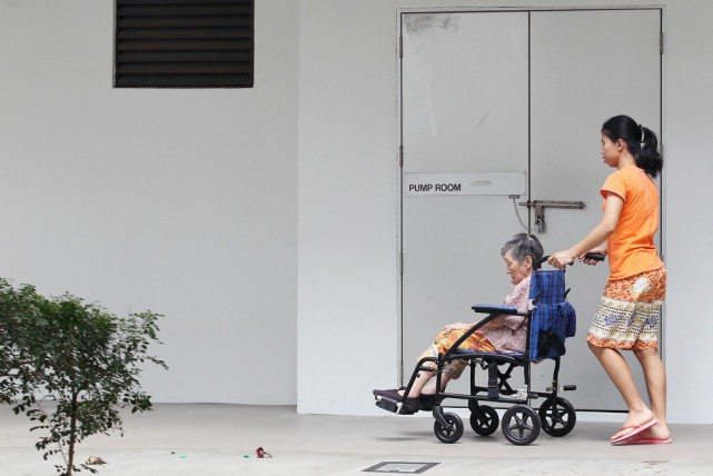 Helper with eldery on wheelchair